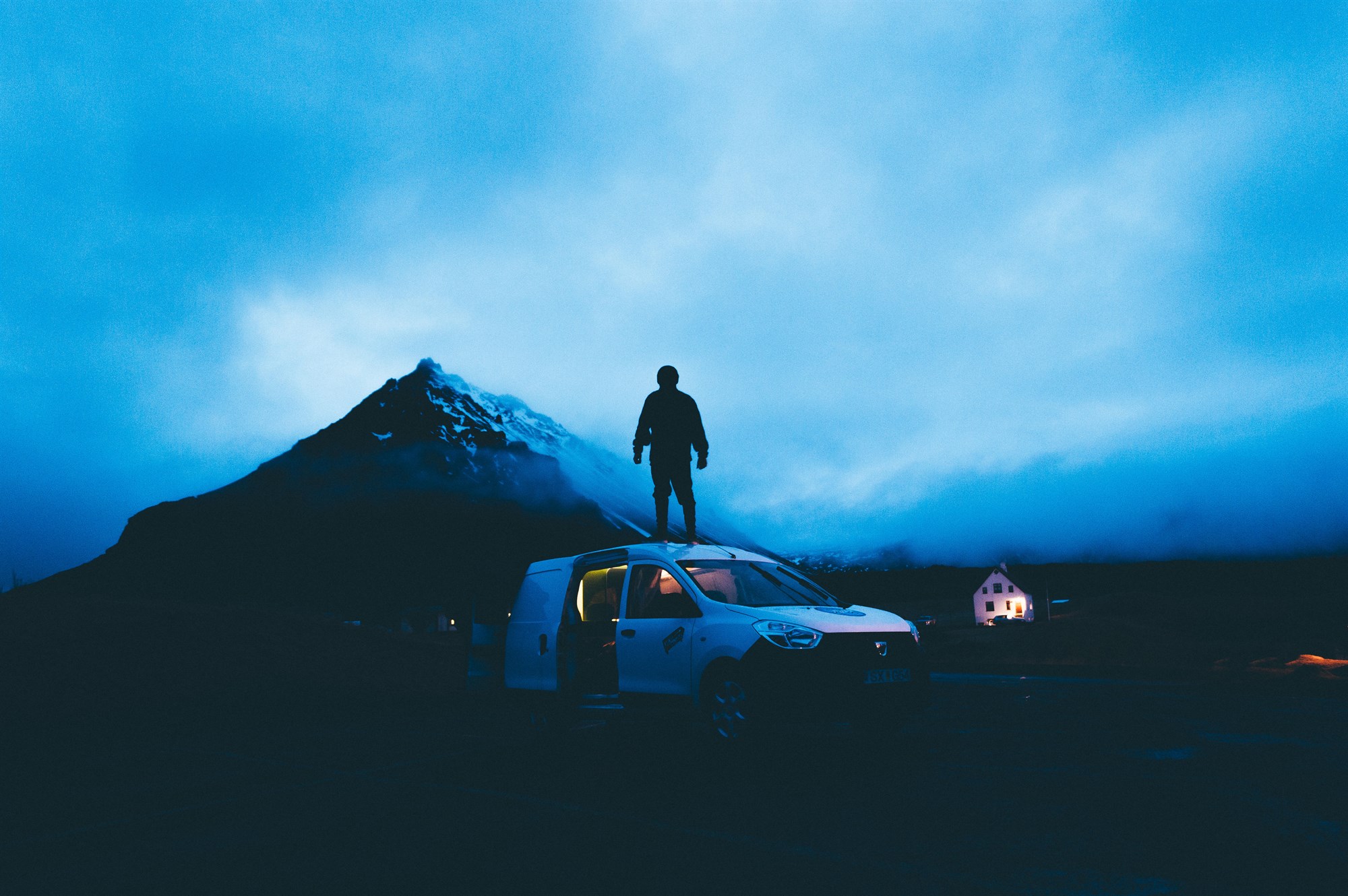 Man standing on a car in Iceland