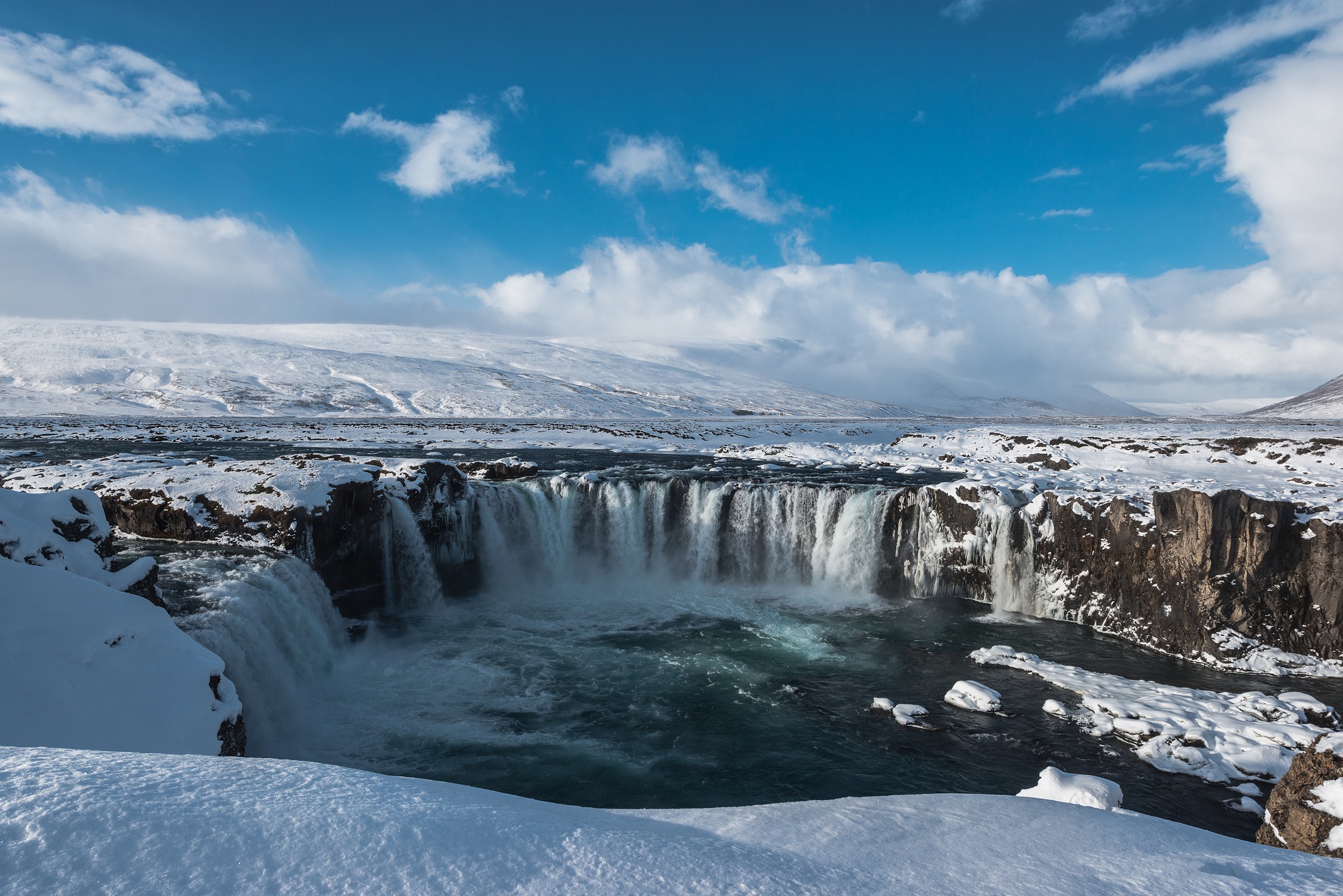 godafoss waterfall during winter with snow