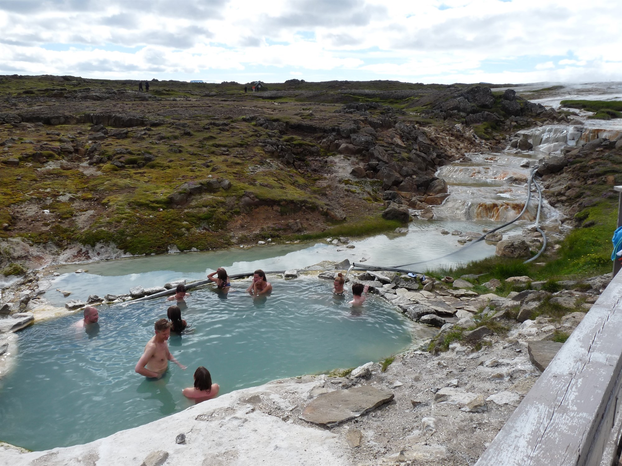 people bathing in Hveravellir hot springs in Iceland