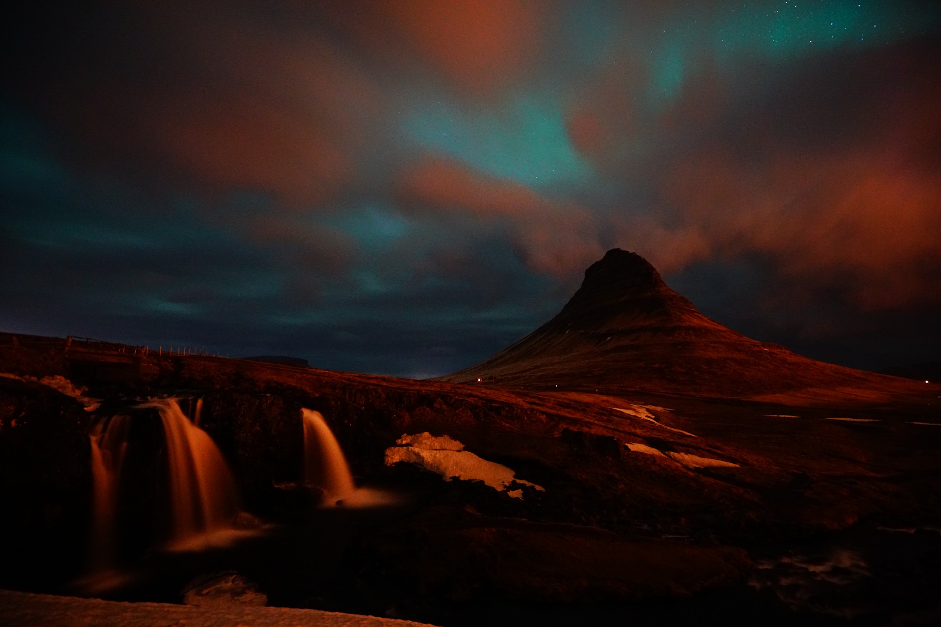 Kirjkjufell in iceland with blue northern lights