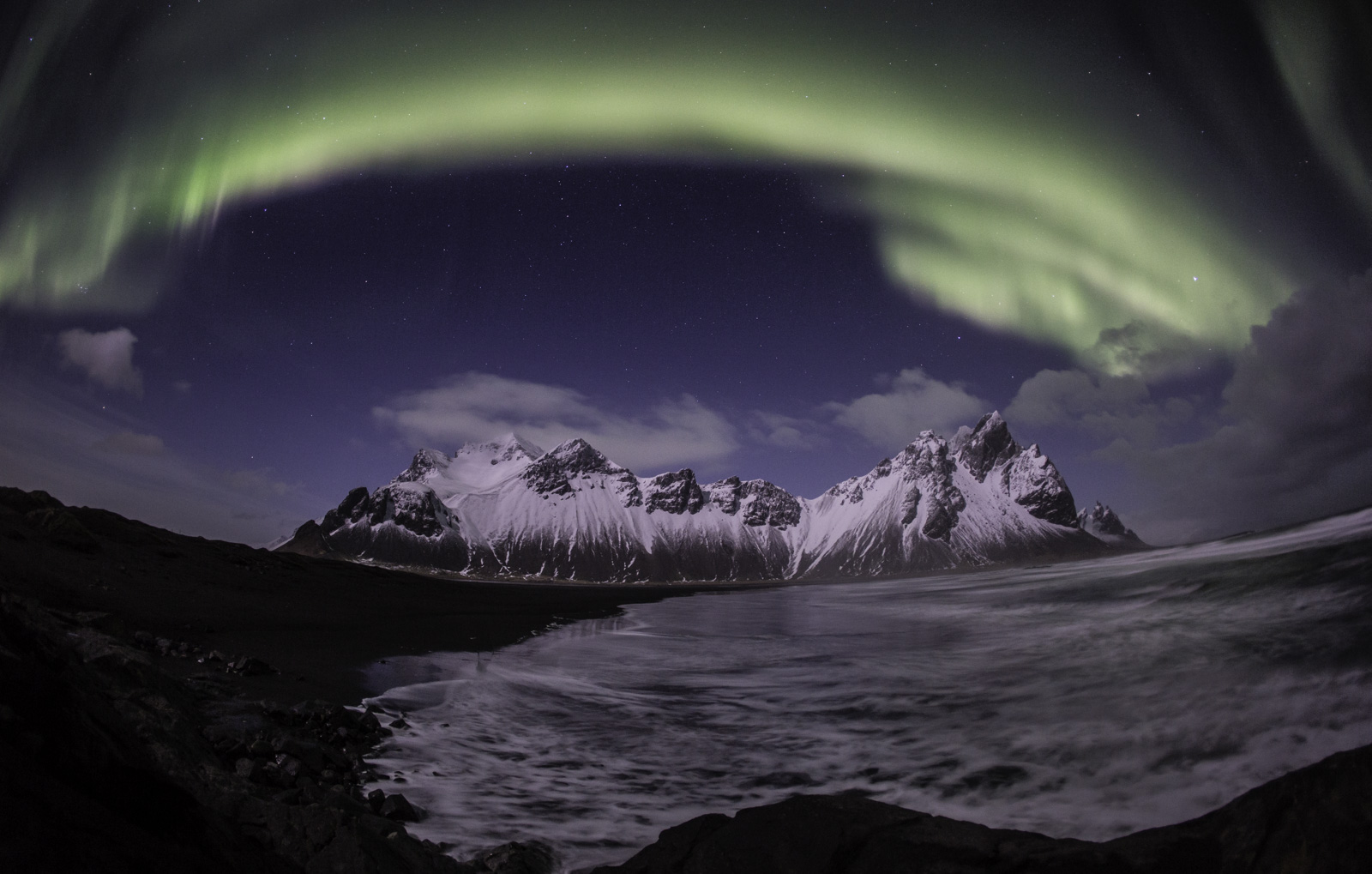 northern lights with mountains in iceland